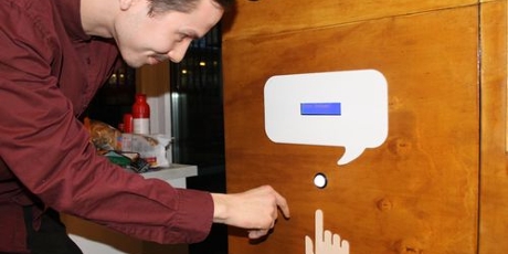 Former student Ruurd pushes the button on the interactive wall for demented people